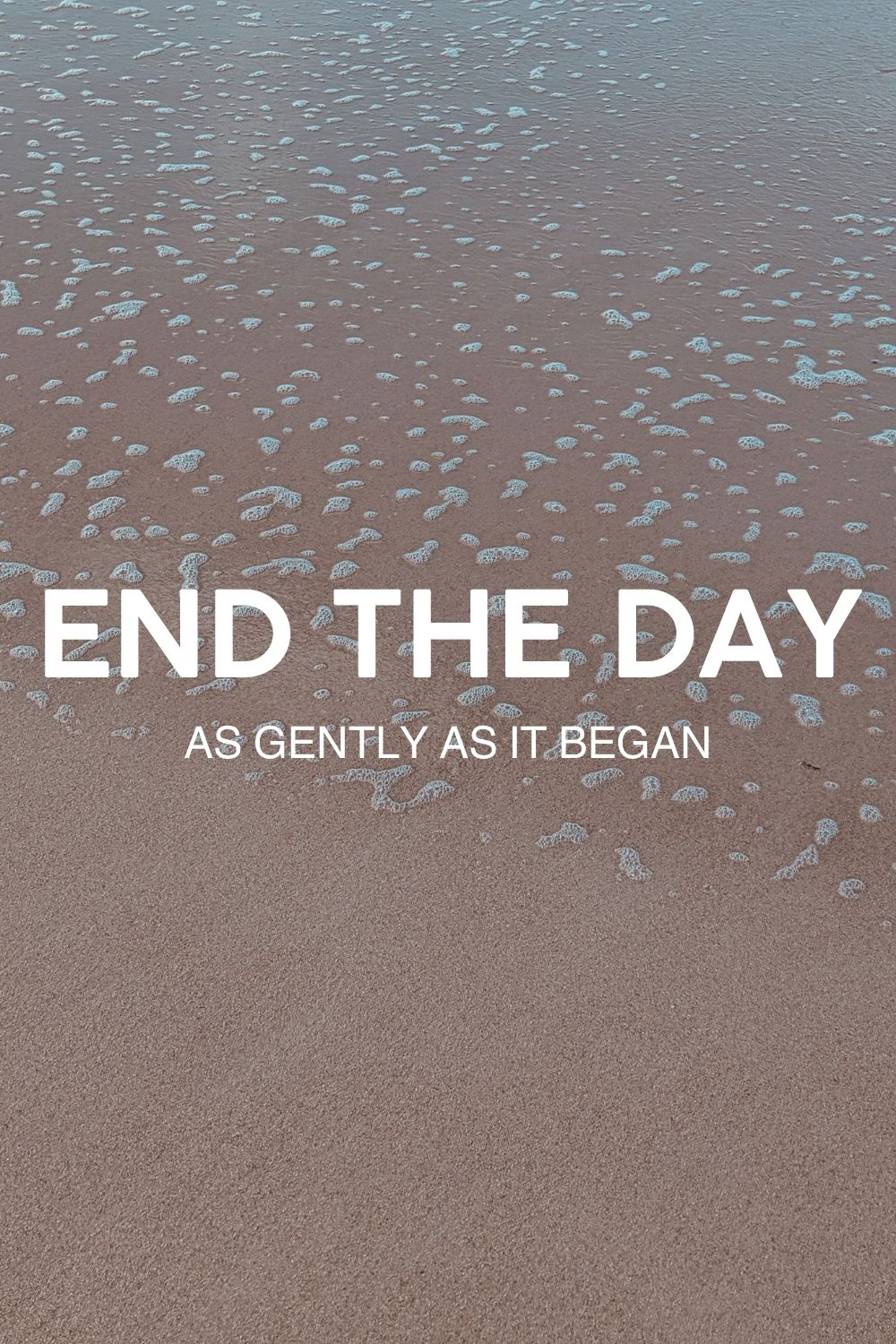 Gentle waves on a sandy beach with overlay text that reads ‘End the day as gently as it began,’ evoking a calming mindfulness ritual.<br/>Evenings are a time to reflect, release, and wind down slowly—just like the tide rolling in.