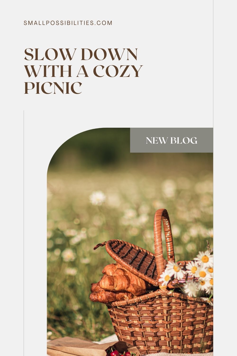 A cozy picnic basket filled with croissants and wildflowers sits in a sunlit field of daisies, highlighting a peaceful moment of slow living and seasonal enjoyment. Perfect for spring picnic inspiration and mindful outdoor moments.